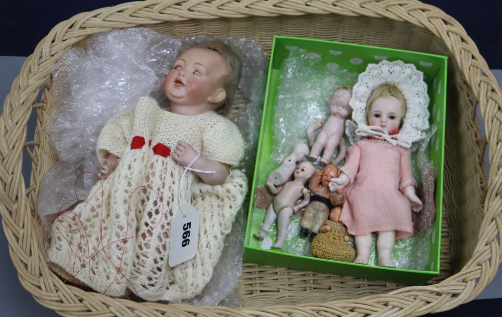 A collection of miniature dolls and an open-mouthed baby bisque headed doll